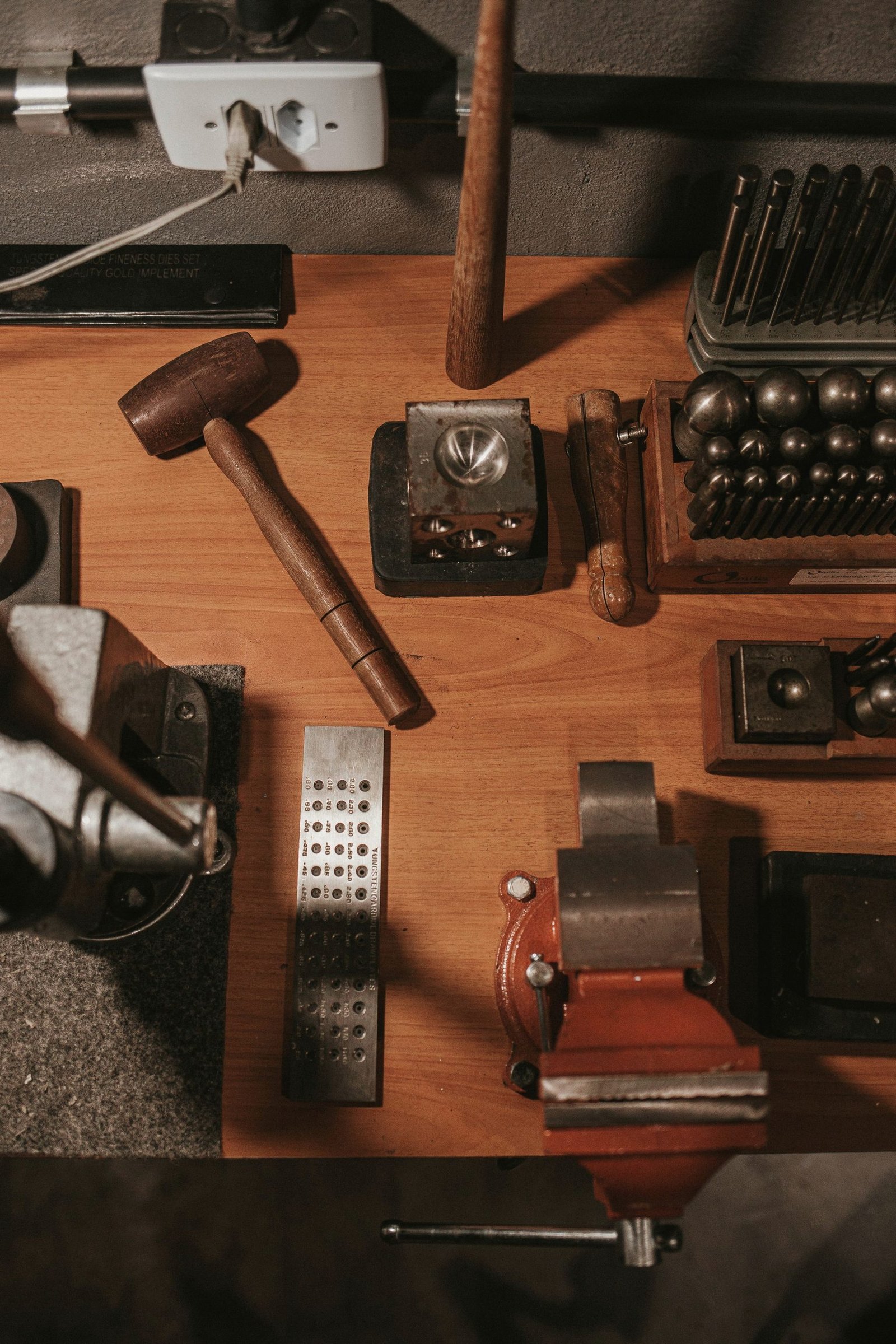 Hand tools laid out across a workshop bench.